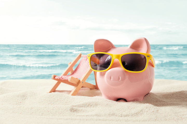 Sparschwein mit Sonnenbrille am Strand, neben einem Liegestuhl und einem Strandtuch. Sparschwein mit Sonnenbrille am Strand, neben einem Liegestuhl und einem Strandtuch.